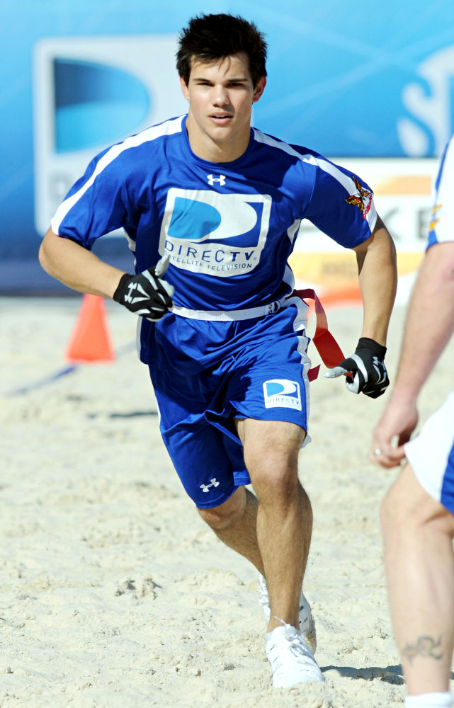 Taylor Lautner;<br>Participate in the Fourth Annual DIRECTV Celebrity Beach Bowl taking pictures