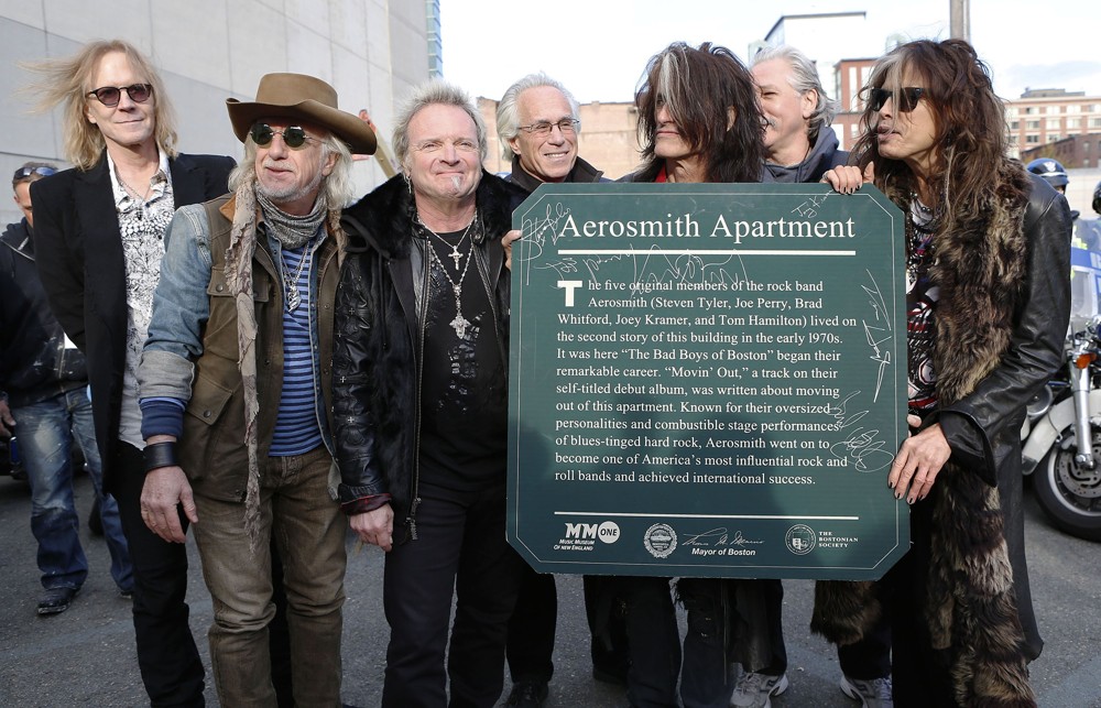 Aerosmith;<br>Aerosmith Hold A Signed Plaque That Is to Be Mounted Outside of 1325 Commonwealth Ave