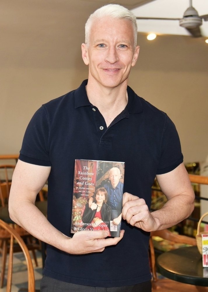 Anderson Cooper Signs Copies of His Book The Rainbow Comes and Goes