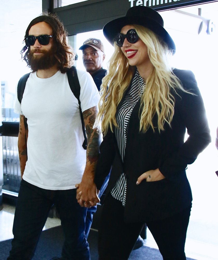 Brad Ashenfelter;Ke$ha;<br>Kesha with Brad Ashenfelter at Los Angeles International Airport