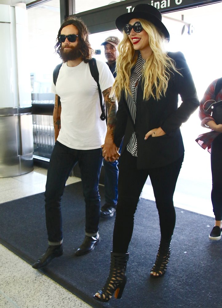 Brad Ashenfelter;Ke$ha;<br>Kesha with Brad Ashenfelter at Los Angeles International Airport