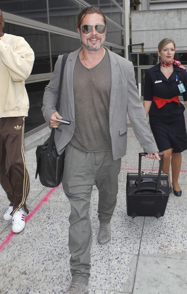 Brad Pitt Arrives at LAX Airport Pulling His Own Suitcase