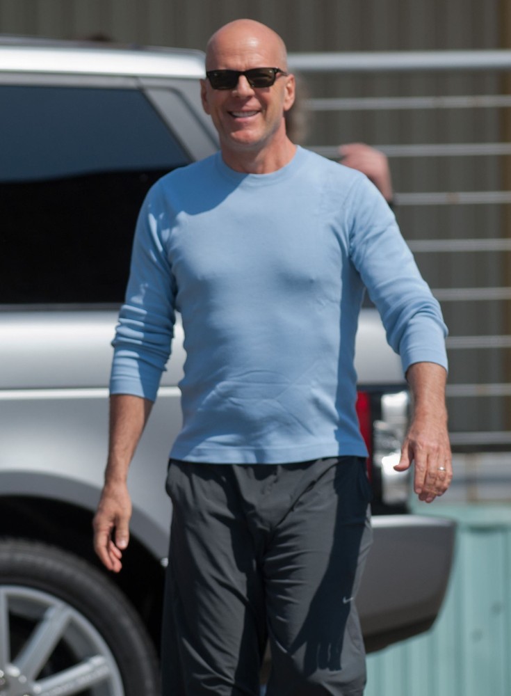 Bruce Willis Waves to Fans at Budapest Airport as He Arrives in The Hungarian Capital