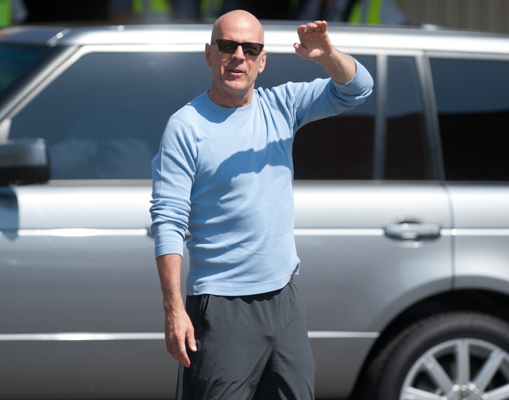 Bruce Willis Waves to Fans at Budapest Airport as He Arrives in The Hungarian Capital