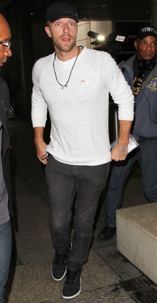 Chris Martin Arrives on A Flight to Los Angeles International Airport