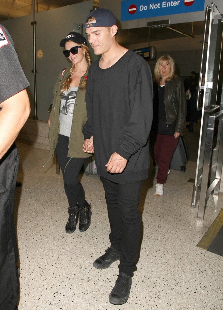 Paris Hilton Arrives at Los Angeles International Airport with Chris Zylka