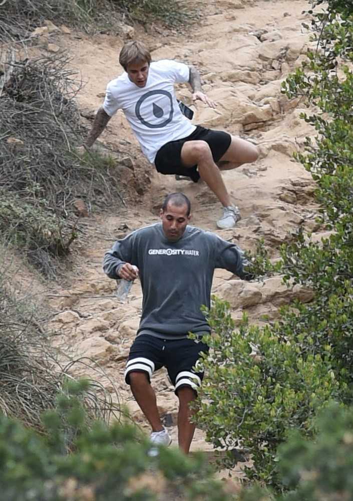 Justin Bieber;<br>Justin Bieber Slips on A Steep Trail and Gets Right Back Up