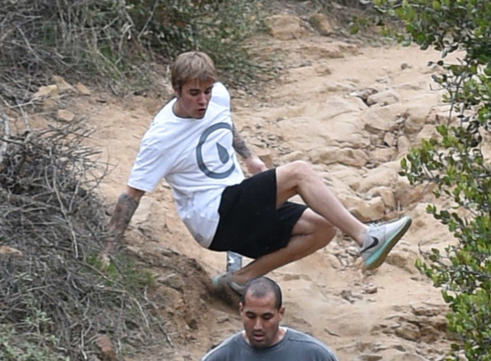Justin Bieber;<br>Justin Bieber Slips on A Steep Trail and Gets Right Back Up