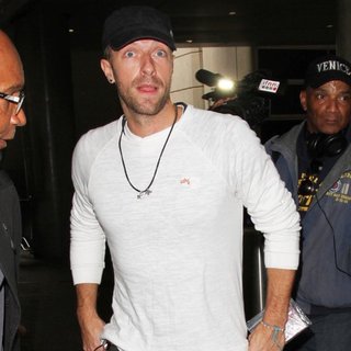 Chris Martin Arrives on A Flight to Los Angeles International Airport