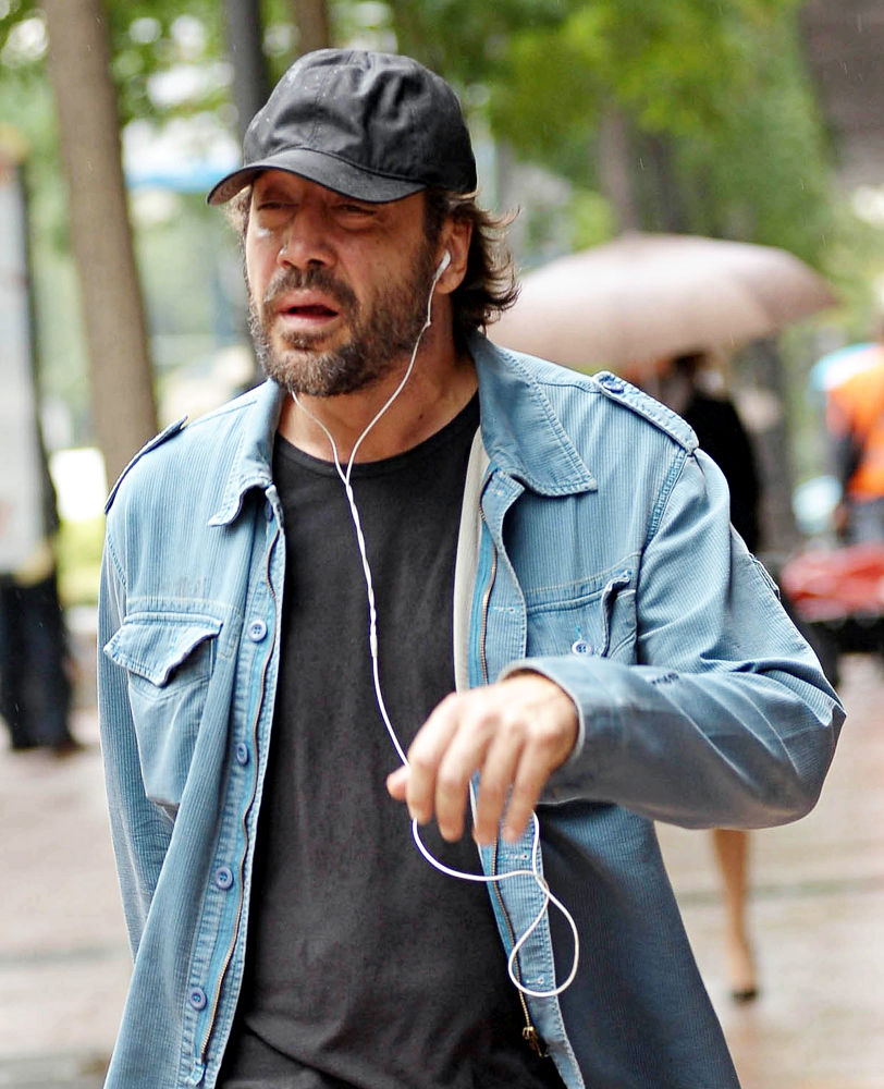 Javier Bardem;<br>Javier Bardem listens to music as he takes a walk in a rainy Madrid