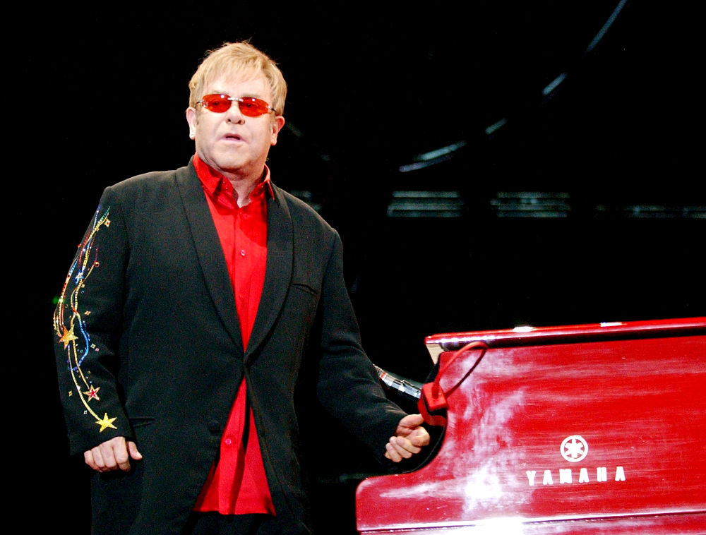 Elton John;<br>Elton John performing live in concert during his 'Red Piano Tour'